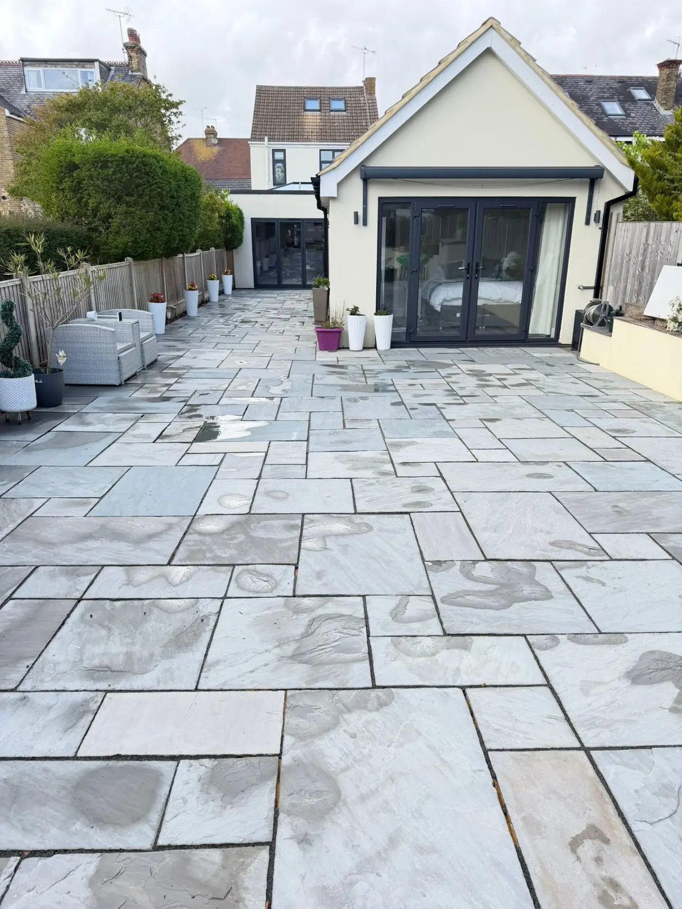 After — moss-covered patio restored with professional pressure washing