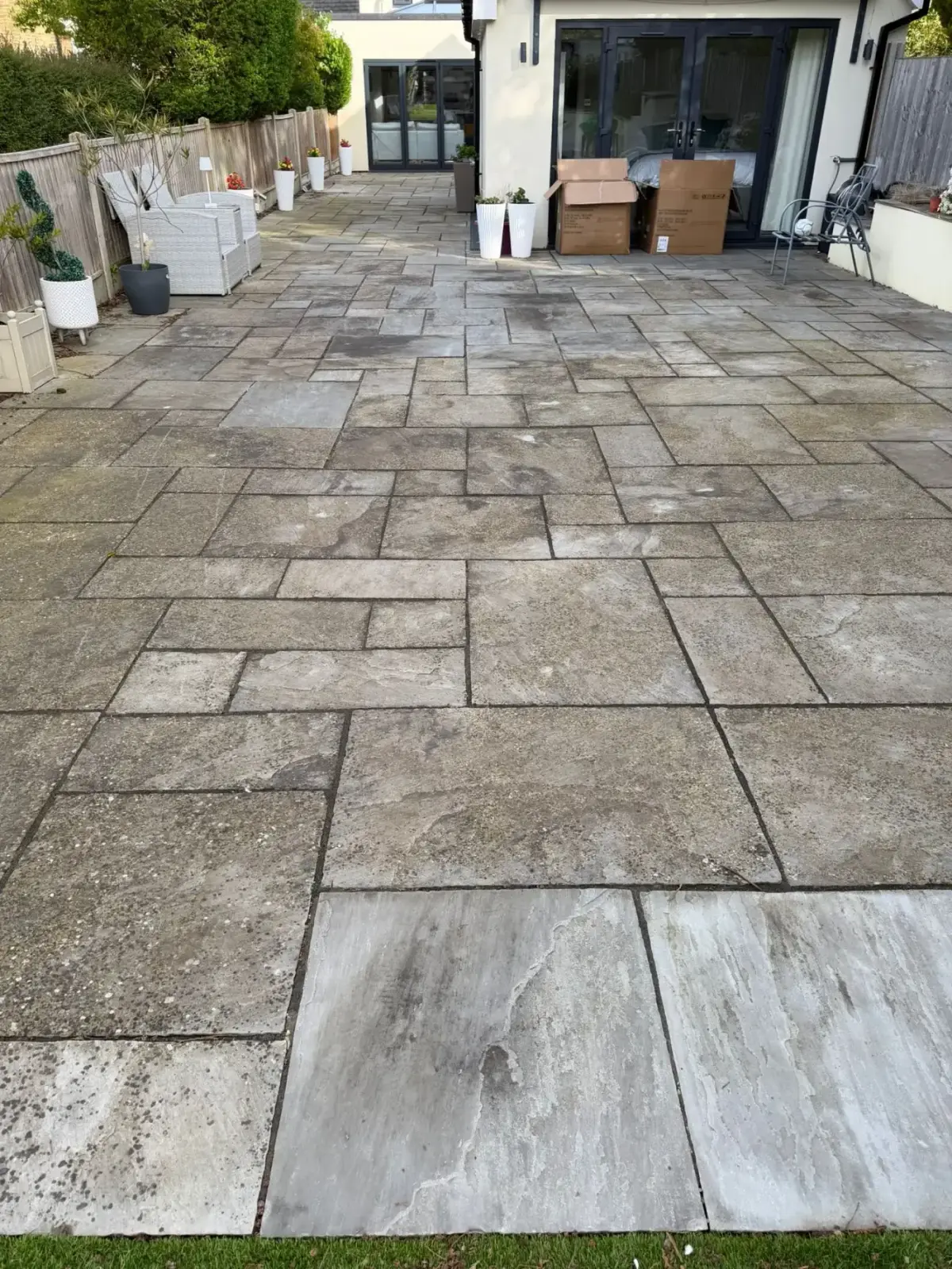 Before — moss-covered patio restored with professional pressure washing